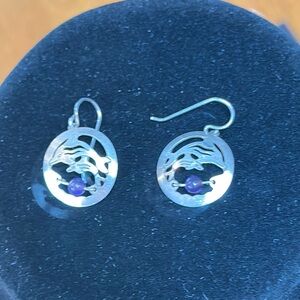 Silver Dolphin earrings within silver and amethyst bead. Fish hook style.